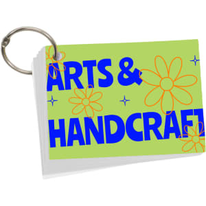 A set of A7 index cards with a ring, featuring a green background and colourful flower designs.