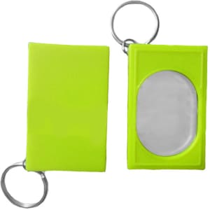 A bright green pet training clicker with a keyring attachment, featuring an oval reflective surface.