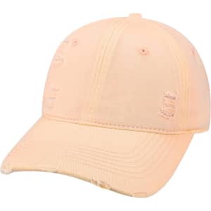 A vintage baseball cap in a soft peach colour, featuring distressed detailing and a curved brim.