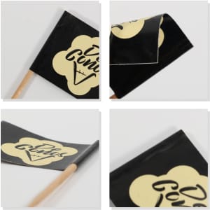 A pack of 100 coated paper flags in black and yellow, featuring a logo on each flag and wooden sticks.