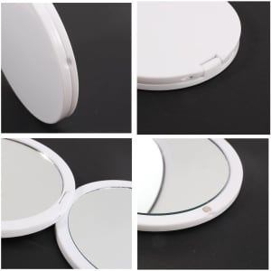 A double-sided round mirror with a white casing, featuring two reflective surfaces and a hinge for opening and closing.