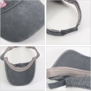 A washed grey sun visor with a light grey band and branded logo, featuring a curved bill and adjustable strap.