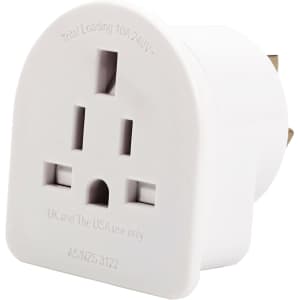 A white travel adapter with multiple sockets, designed for use in Australasia and compatible with various plug types.