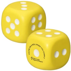 A yellow dice-shaped stress reliever with white dots and a logo on one side.