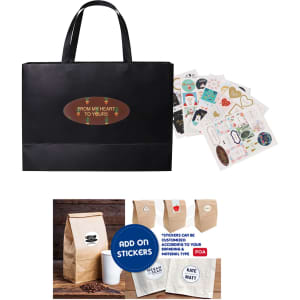 A black medium paper bag with flat handles, accompanied by assorted stickers and a small brown paper bag.