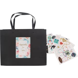 A medium black paper bag with knitted handles, accompanied by colourful decorative stickers.