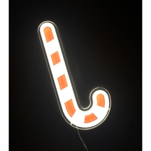A neon LED sign shaped like a candy cane, featuring red and white stripes against a dark background.