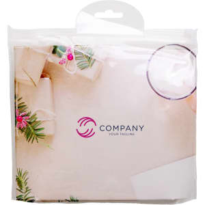 A clear packaging featuring a toiletry bag kit with decorative elements in soft colours and a logo on the front.