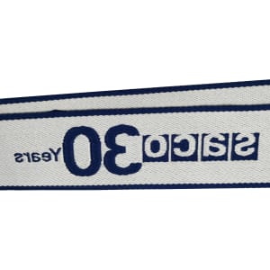 A woven luggage belt in navy blue and white with a logo and decorative text.