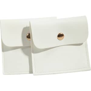 A set of two white PU leather jewelry pouches featuring a snap button closure and a sleek design.