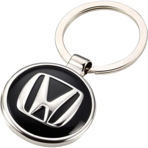 A silver keyring featuring a round black and silver embossed logo. The keyring has a smooth finish and a metal loop.