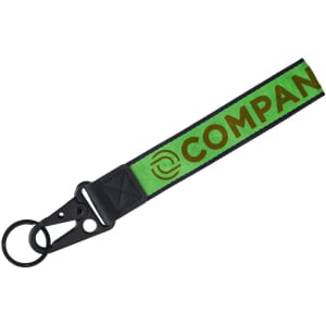 A green and black Jacquard keyring featuring a logo and a sturdy clip for attachment.