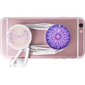 A pink phone with two decorative pop holders and white earphones bundled together.