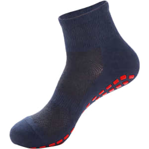 A pair of dark blue crew socks with a textured design and red non-slip grip on the sole.