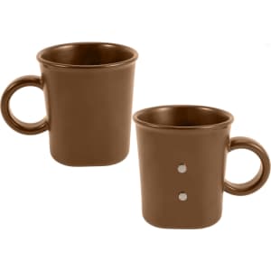 A brown ceramic coffee mug with a handle and two magnetic dots on the side, featuring a simple design.