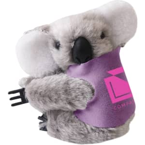 A grey koala plush toy with large ears and a purple vest, holding a small fork, featuring a logo.
