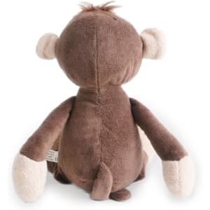 A brown plush monkey toy with light-coloured hands and ears, featuring a small tuft of fur on its head.