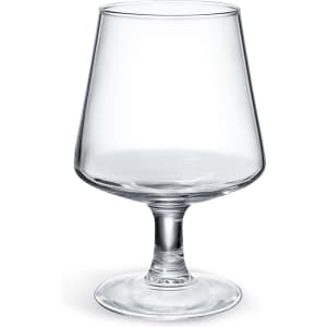 A crystal clear brandy snifter with a wide bowl and a slender stem, showcasing its elegant design.