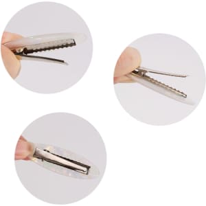 An oval iridescent alligator hair clip, showcasing its shiny surface and clip mechanism, held between fingers.