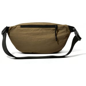A large bum bag in khaki with a zippered pocket and a black adjustable strap. Features a logo on the surface.