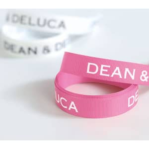 Ribbed fabric ribbons in pink and white, featuring text and a logo. Each ribbon is 22mm in width.
