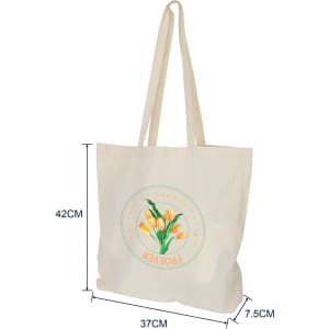 A cream calico bag with long handles and a gusset, featuring a floral logo design.