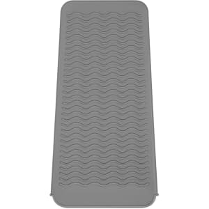 A grey heat-resistant silicone mat pouch with a textured wave design. It features a smooth edge and is flexible in shape.