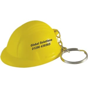 A yellow helmet stress reliever attached to a silver keyring, featuring branding on the side.