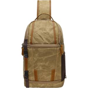 A waxed canvas camera sling bag in khaki and brown, featuring leather accents and a logo.
