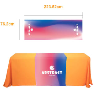 A large table runner featuring a gradient of pink and blue colours with an orange tablecloth underneath. It includes a logo.