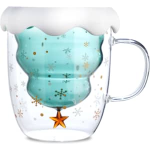 A double wall mug shaped like a Christmas tree, featuring a frosted white top, blue interior, and festive gold and silver details.