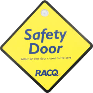 A diamond-shaped yellow warning sign with a black border and a logo, labelled "Safety Door".