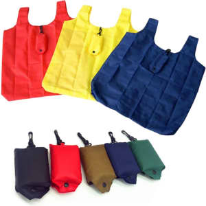 A collection of compact foldable shopping tote bags in red, yellow, navy, and various coloured pouches for storage.