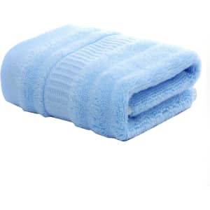 A blue bamboo fiber towel neatly folded, designed for leisure and gym use, with a textured surface.