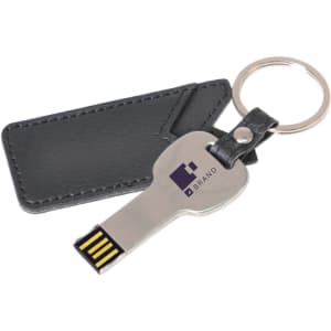 A silver flash drive shaped like a key, with a black leather pouch and keyring attached.