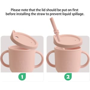 A drink bottle in soft pink silicone featuring dual handles and a detachable straw. It has a logo on the front.