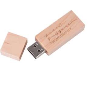 A wooden rectangle flash drive in light wood, featuring a removable cap and a logo engraved on its surface.