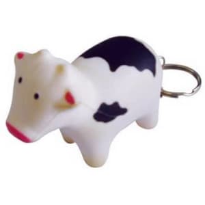A keyring featuring a white and black cow stress reliever with a silver keyring attachment.