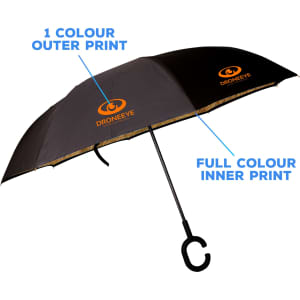 A reversible folding umbrella with a black outer and a full colour inner print, featuring a logo.