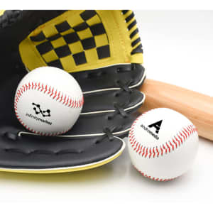 Two white training baseballs with red stitching, positioned next to a black glove and wooden bat. Each ball has a logo.