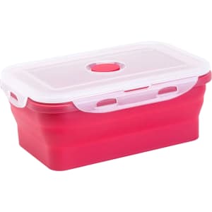A collapsible silicone food storage container in pink and white with a transparent lid and a small opening.