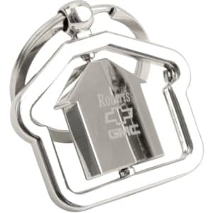 A silver metal keyring shaped like a house, featuring a central house design and a branding logo.