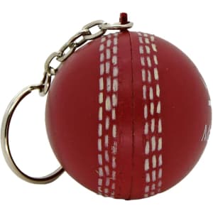 A red cricket ball stress reliever keyring with white stitching and a metal chain for attachment.