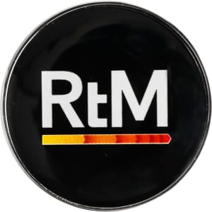 A 25mm round golf ball marker featuring a black background and a logo in white and orange-yellow colours.