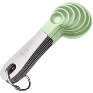 A set of stainless steel measuring spoons in green, featuring a metal ring for easy storage.