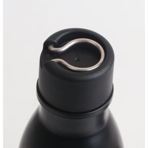 A drink bottle with a black stainless steel body and a metallic loop on the cap for easy handling.
