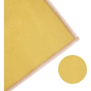 A yellow polyester logo mat with a textured surface and a stitched border, featuring a circular colour swatch.