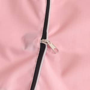 A close-up of a pink foldable tote bag featuring a zipper and a contrasting black lining.
