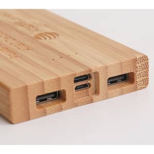 A bamboo power bank with multiple charging ports, featuring a natural wood finish. It includes USB and USB-C connections.