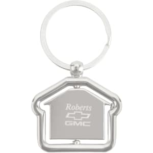 A silver metal keyring in the shape of a house, with a circular keyring attachment.